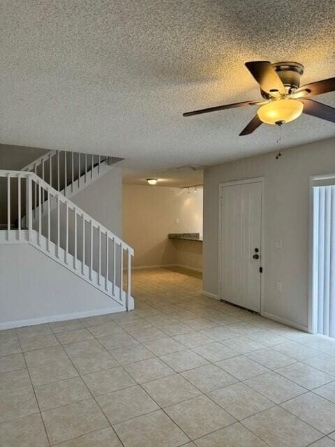 3822 38th Way, West Palm Beach, FL 33407 - entrance foyer featuring ceiling fan, a textured ceiling, and light tile patterned floors