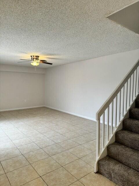 3822 38th Way, West Palm Beach, FL 33407 - unfurnished room featuring stairway, a ceiling fan, a textured ceiling, and light tile patterned floors