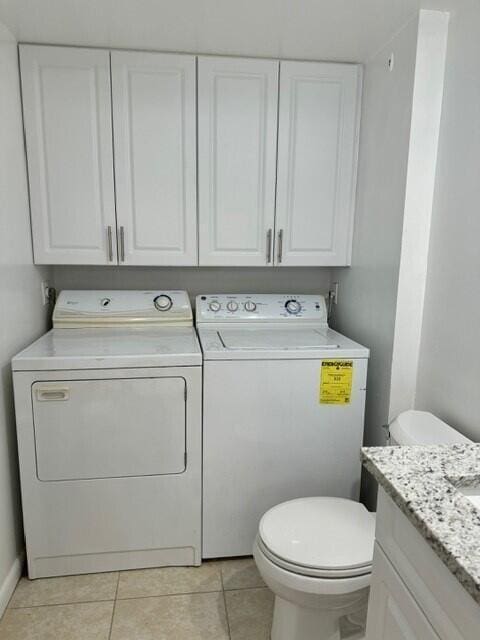 3822 38th Way, West Palm Beach, FL 33407 - bathroom featuring washer and dryer, tile patterned floors, and vanity