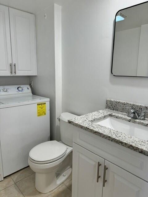 3822 38th Way, West Palm Beach, FL 33407 - bathroom with washer / dryer, vanity, and tile patterned flooring