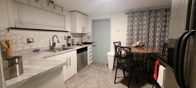 104 NE 5th St, Fort Lauderdale, FL 33301 - kitchen featuring refrigerator with ice dispenser, stainless steel dishwasher, white cabinets, and decorative backsplash