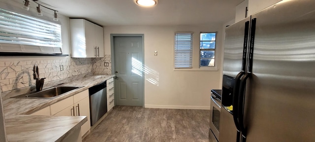 104 NE 5th St, Fort Lauderdale, FL 33301 - kitchen featuring stainless steel appliances, light countertops, backsplash, dark wood-style floors, and white cabinetry