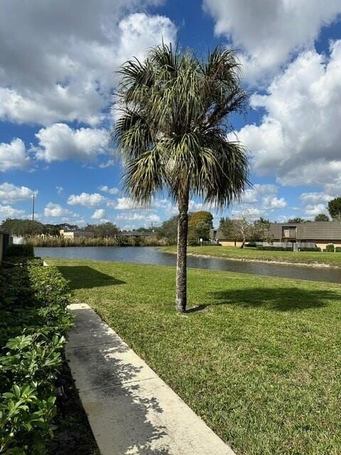 3819 38th Way, West Palm Beach, FL 33407 - view of community featuring a water view and a yard