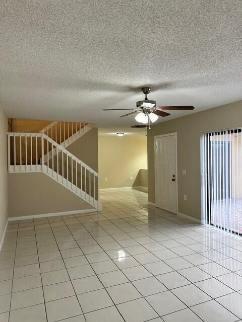 3819 38th Way, West Palm Beach, FL 33407 - unfurnished room with a ceiling fan, light tile patterned floors, and a textured ceiling
