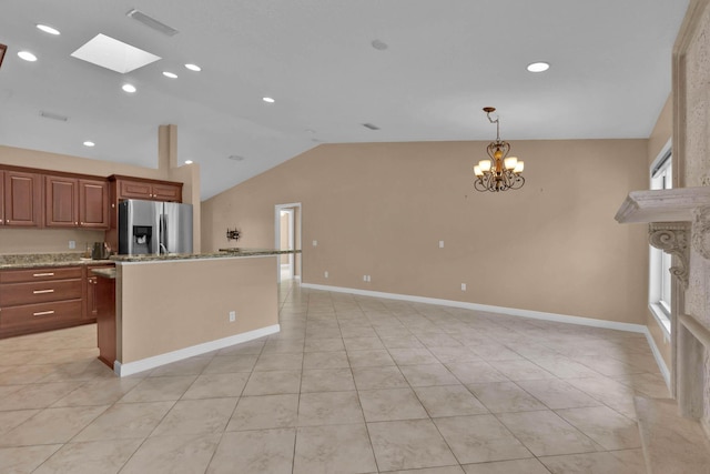 1070 SW Jennifer Ter, Port Saint Lucie, FL 34953 - kitchen featuring stainless steel refrigerator with ice dispenser, vaulted ceiling, a chandelier, a skylight, and pendant lighting