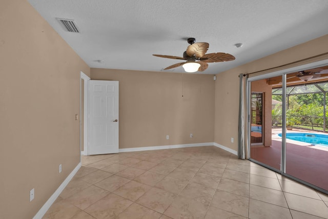 1070 SW Jennifer Ter, Port Saint Lucie, FL 34953 - spare room with ceiling fan, light tile patterned flooring, and a textured ceiling