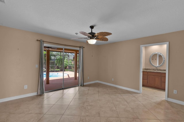 1070 SW Jennifer Ter, Port Saint Lucie, FL 34953 - empty room with a ceiling fan, light tile patterned floors, and a textured ceiling
