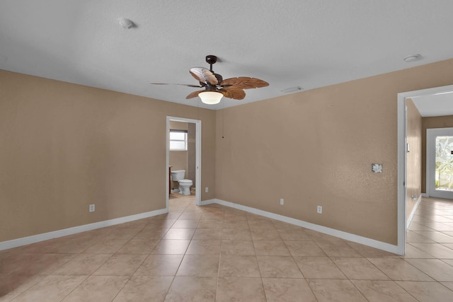 1070 SW Jennifer Ter, Port Saint Lucie, FL 34953 - empty room with ceiling fan, light tile patterned flooring, a smoke detector, and a textured ceiling