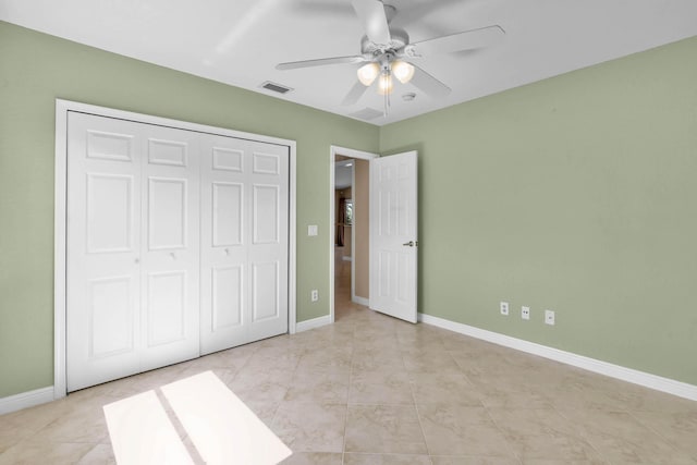 1070 SW Jennifer Ter, Port Saint Lucie, FL 34953 - unfurnished bedroom featuring a closet, a ceiling fan, and light tile patterned flooring