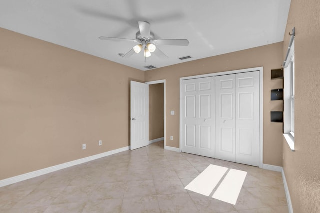 1070 SW Jennifer Ter, Port Saint Lucie, FL 34953 - unfurnished bedroom with a closet, a ceiling fan, and light tile patterned floors
