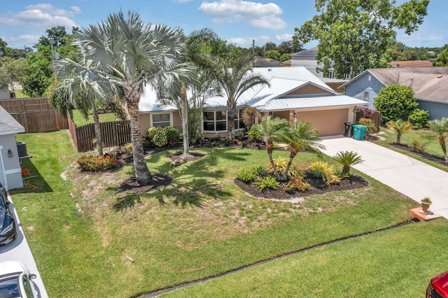 1070 SW Jennifer Ter, Port Saint Lucie, FL 34953 - view of front of house featuring concrete driveway, a garage, a metal roof, and stucco siding