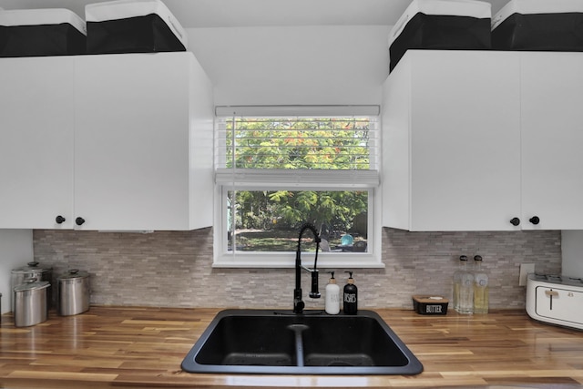 2626 Garfield St, Hollywood, FL 33020 - kitchen featuring white cabinets, decorative backsplash, wood finished floors, and butcher block countertops