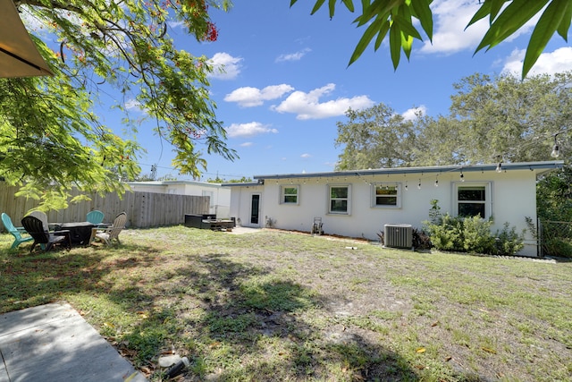 2626 Garfield St, Hollywood, FL 33020 - back of property with stucco siding and an outdoor fire pit