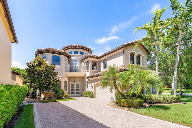 8199 Lost Creek Ln, Delray Beach, FL 33446 - mediterranean / spanish home featuring decorative driveway, a garage, stucco siding, french doors, and a tile roof