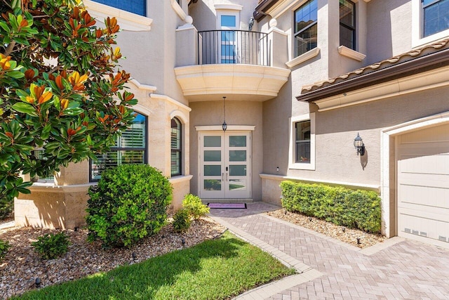 8199 Lost Creek Ln, Delray Beach, FL 33446 - property entrance featuring a balcony, stucco siding, and french doors