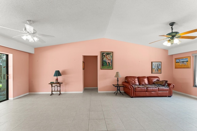 1107 SE Cambridge Dr, Port Saint Lucie, FL 34952 - living room featuring ceiling fan, light tile patterned floors, lofted ceiling, and a textured ceiling