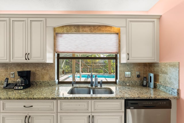 1107 SE Cambridge Dr, Port Saint Lucie, FL 34952 - kitchen with stainless steel dishwasher, backsplash, and light stone counters