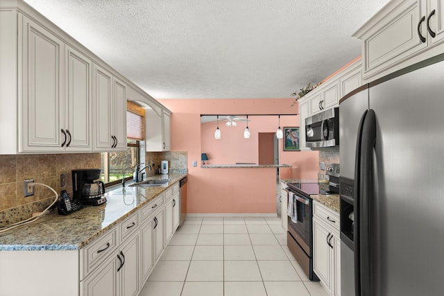 1107 SE Cambridge Dr, Port Saint Lucie, FL 34952 - kitchen with appliances with stainless steel finishes, decorative backsplash, a textured ceiling, light stone counters, and light tile patterned floors