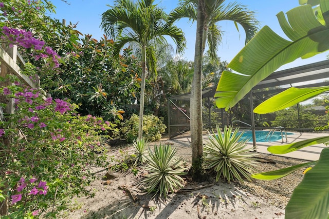 1107 SE Cambridge Dr, Port Saint Lucie, FL 34952 - view of yard featuring an outdoor pool and a lanai