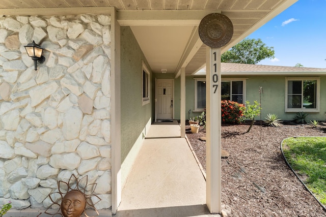 1107 SE Cambridge Dr, Port Saint Lucie, FL 34952 - view of exterior entry with stone siding and stucco siding