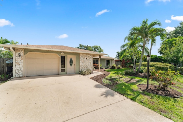1107 SE Cambridge Dr, Port Saint Lucie, FL 34952 - single story home featuring a garage, driveway, and stone siding
