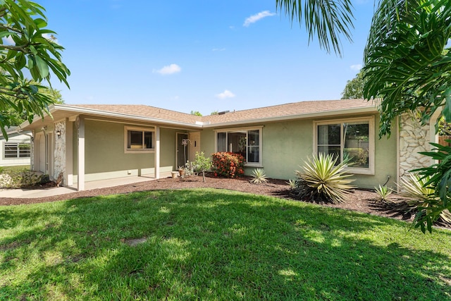 1107 SE Cambridge Dr, Port Saint Lucie, FL 34952 - ranch-style house with stucco siding and a front yard