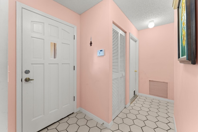 1107 SE Cambridge Dr, Port Saint Lucie, FL 34952 - foyer entrance with a textured ceiling and baseboards