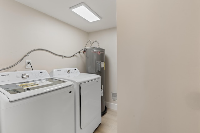 401 Vision Ct, Palm Beach Gardens, FL 33418 - washroom featuring washing machine and clothes dryer, light wood-type flooring, and electric water heater
