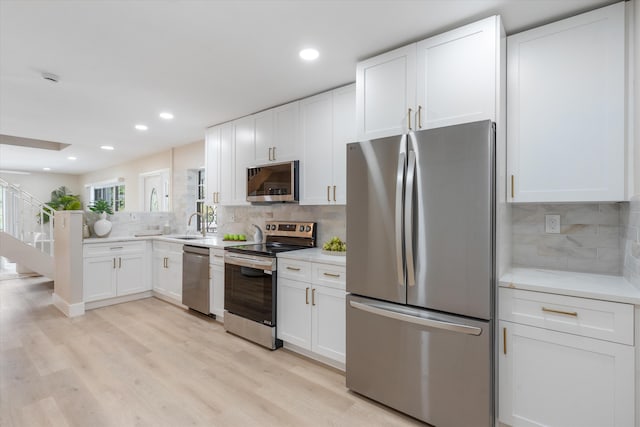 401 Vision Ct, Palm Beach Gardens, FL 33418 - kitchen with appliances with stainless steel finishes, decorative backsplash, light countertops, white cabinets, and recessed lighting