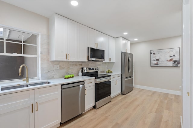 401 Vision Ct, Palm Beach Gardens, FL 33418 - kitchen with appliances with stainless steel finishes, tasteful backsplash, white cabinets, light countertops, and recessed lighting