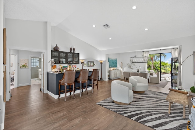 31 Dunbar Rd, Palm Beach Gardens, FL 33418 - living room with bar area, wood finished floors, recessed lighting, and high vaulted ceiling