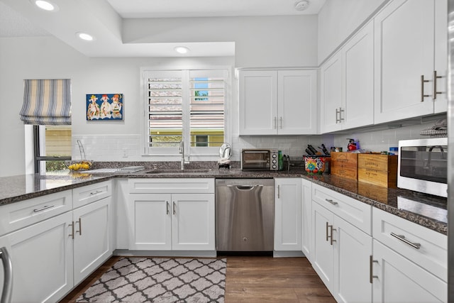 31 Dunbar Rd, Palm Beach Gardens, FL 33418 - kitchen with appliances with stainless steel finishes, white cabinets, recessed lighting, tasteful backsplash, and dark wood finished floors