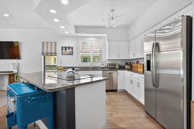 31 Dunbar Rd, Palm Beach Gardens, FL 33418 - kitchen featuring stainless steel appliances, white cabinets, recessed lighting, a kitchen island, and light wood-type flooring