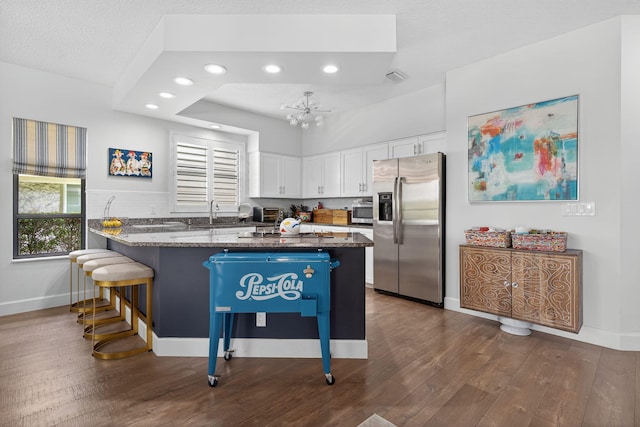 31 Dunbar Rd, Palm Beach Gardens, FL 33418 - kitchen with stainless steel appliances, a peninsula, white cabinets, dark wood-type flooring, and recessed lighting
