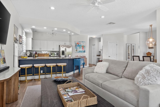 31 Dunbar Rd, Palm Beach Gardens, FL 33418 - living area featuring ceiling fan, recessed lighting, dark wood finished floors, a chandelier, and a textured ceiling