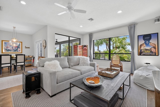 31 Dunbar Rd, Palm Beach Gardens, FL 33418 - living area with plenty of natural light, wood finished floors, a ceiling fan, a textured ceiling, and recessed lighting
