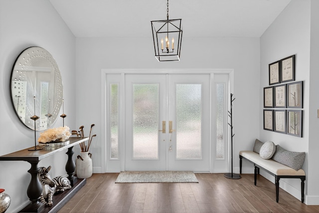 31 Dunbar Rd, Palm Beach Gardens, FL 33418 - foyer entrance featuring french doors, a chandelier, and wood finished floors