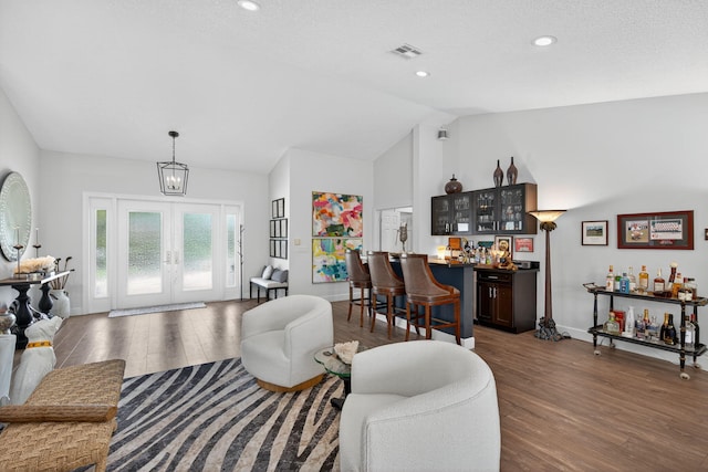 31 Dunbar Rd, Palm Beach Gardens, FL 33418 - living area featuring lofted ceiling, a bar, dark wood finished floors, and recessed lighting