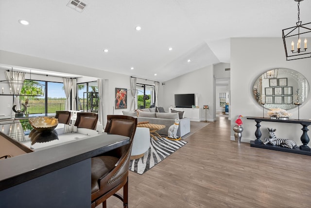 31 Dunbar Rd, Palm Beach Gardens, FL 33418 - dining space with plenty of natural light, wood finished floors, vaulted ceiling, a chandelier, and recessed lighting