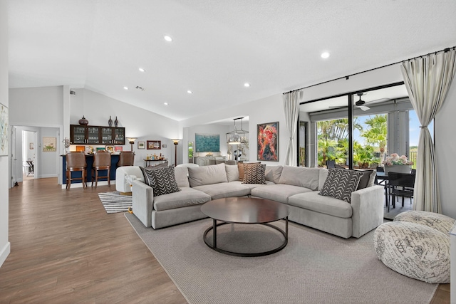 31 Dunbar Rd, Palm Beach Gardens, FL 33418 - living area featuring recessed lighting, wood finished floors, bar, and high vaulted ceiling