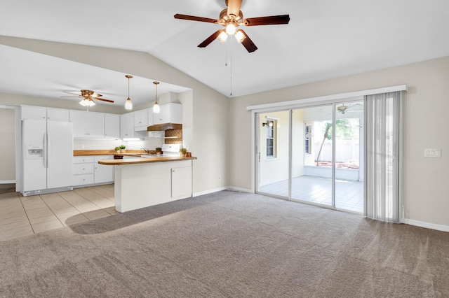 1360 39th Ave, Vero Beach, FL 32960 - kitchen featuring white fridge with ice dispenser, ceiling fan, vaulted ceiling, light carpet, and white cabinetry
