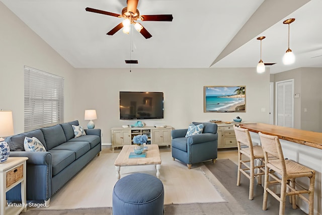 1360 39th Ave, Vero Beach, FL 32960 - living room featuring lofted ceiling, a ceiling fan, and light wood-style flooring