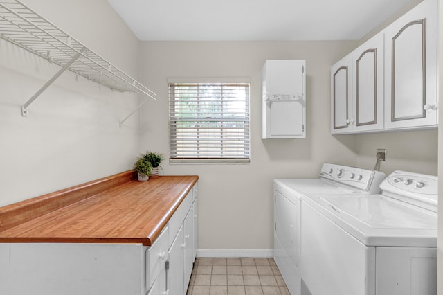 1360 39th Ave, Vero Beach, FL 32960 - laundry area featuring washer and dryer, cabinet space, and light tile patterned floors
