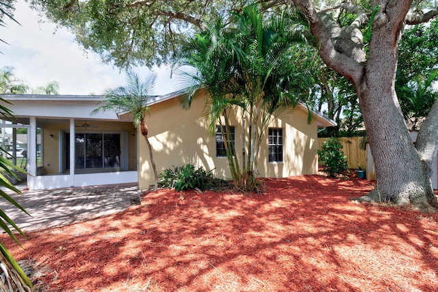 1360 39th Ave, Vero Beach, FL 32960 - view of home's exterior with stucco siding, a ceiling fan, and a sunroom