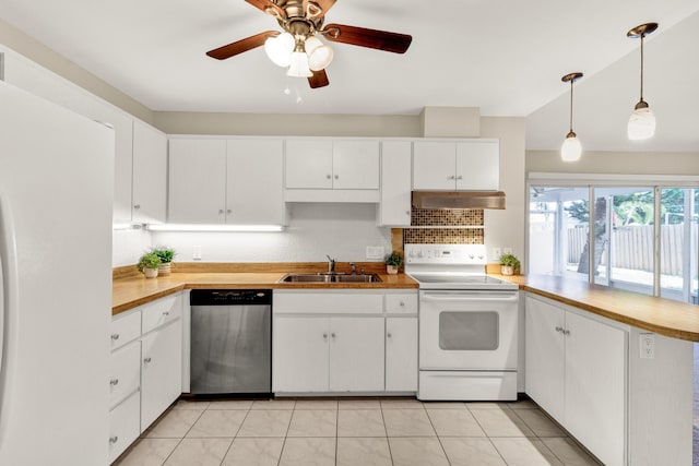 1360 39th Ave, Vero Beach, FL 32960 - kitchen with white appliances, a peninsula, backsplash, under cabinet range hood, and white cabinetry