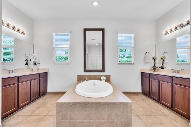 6458 SW Key Deer Ln, Palm City, FL 34990 - bathroom featuring two vanities, tile patterned flooring, a bath, and plenty of natural light