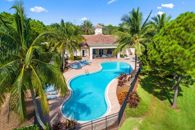 6458 SW Key Deer Ln, Palm City, FL 34990 - community pool with a patio area and a lawn