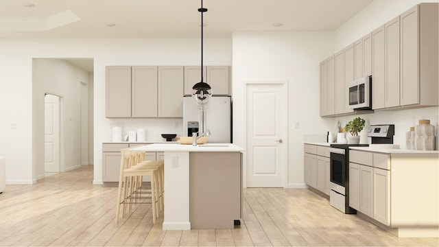 1153 SE Crosswood Way, Port Saint Lucie, FL 34987 - kitchen with electric range, white microwave, refrigerator with ice dispenser, light wood-style floors, and an island with sink