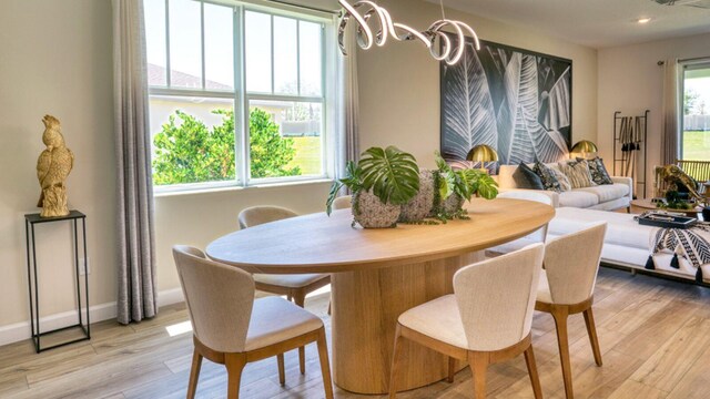1488 SE Crosswood Way, Port Saint Lucie, FL 34984 - dining room featuring light wood-style floors, a chandelier, and recessed lighting