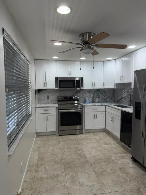 3510 Oaks Way Unit 103, Pompano Beach, FL 33069 - kitchen featuring appliances with stainless steel finishes, a ceiling fan, white cabinetry, and recessed lighting